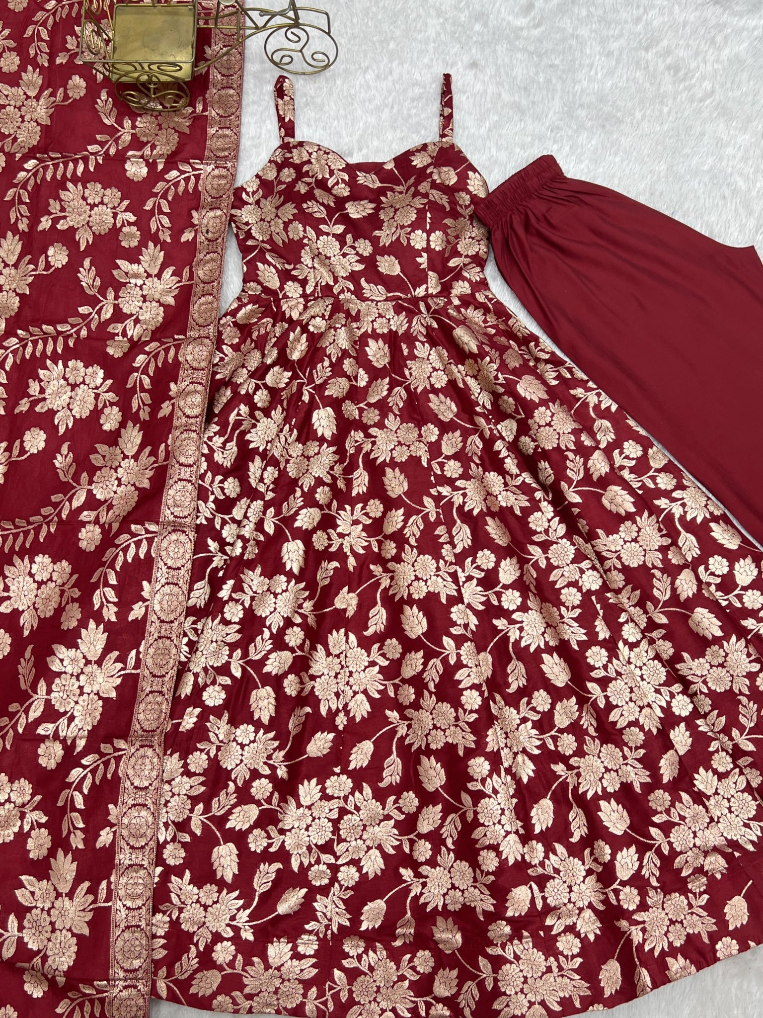 Maroon Banarasi jacquard suit with dupatta border and straight pant flat lay